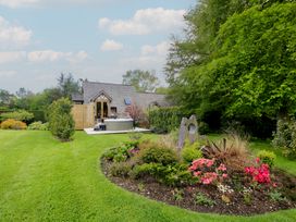 A garden with flowers and a hot tub at Pultheley Cottage Hyssington near Churchstoke