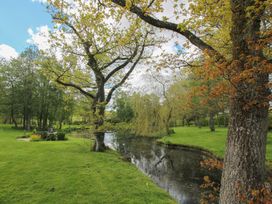 An outdoor space with trees and a river at Pultheley Cottage Hyssington near Churchstoke