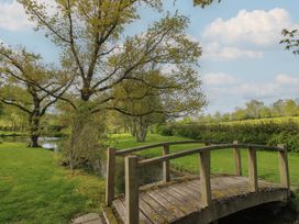 A bridge over a stream in a garden at Pultheley Cottage Hyssington near Churchstoke