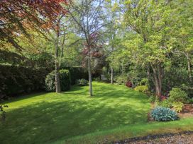 A garden with trees and grass at Pultheley Cottage Hyssington near Churchstoke