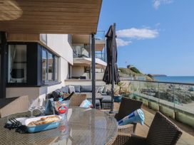 An outdoor seating area with a dining table and sofa at 4 Burgh Island Causeway Bigbury