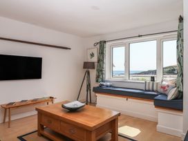 A living room with a window seat and television at 4 Burgh Island Causeway Bigbury