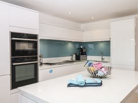 A kitchen with appliances and a bowl of items at 4 Burgh Island Causeway Bigbury