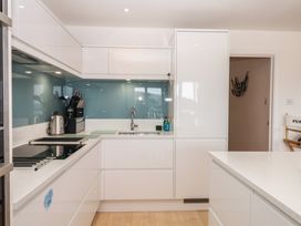 A kitchen with cabinets, sink, and cooktop at 4 Burgh Island Causeway in Bigbury