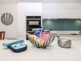 A kitchen with a table and fruit bowl at 4 Burgh Island Causeway in Bigbury