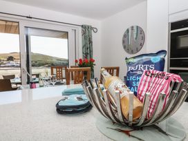 A kitchen with a bottle and snacks on the counter at 4 Burgh Island Causeway Bigbury