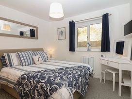 A bedroom with a bed and a dressing table at 4 Burgh Island Causeway in Bigbury