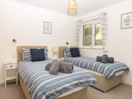 A bedroom with two beds and a window at 4 Burgh Island Causeway Bigbury