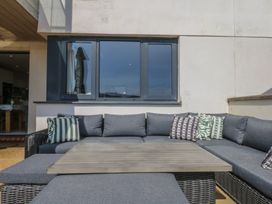 An outdoor seating area with a sectional sofa and coffee table at 4 Burgh Island Causeway Bigbury