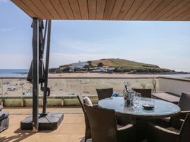 An outdoor patio with a view of the beach and ocean at 4 Burgh Island Causeway in Bigbury