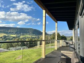 An outdoor deck with a view of mountains at Osprey View Lodge & Hot Tub Aberfeldy