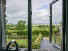 A view from a window showing fields and trees at Fell View Cottage Lambrigg near Kendal
