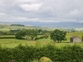 A landscape with trees and a stone building at Fell View Cottage, Lambrigg near Kendal