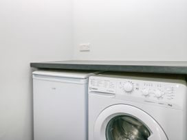 A laundry room with a washing machine and freezer at Fell View Cottage Lambrigg near Kendal