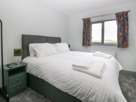 A bedroom with a bed and a bedside table at Fell View Cottage Lambrigg near Kendal