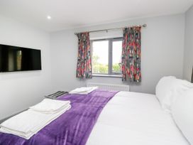 A bedroom with a bed and a television at Fell View Cottage in Lambrigg near Kendal