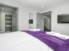 A bedroom with a bed and television at Fell View Cottage in Lambrigg near Kendal
