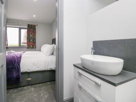 A bedroom with a bed and sink at Fell View Cottage Lambrigg near Kendal