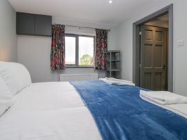 A bedroom with a bed and a window at Fell View Cottage Lambrigg near Kendal