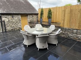 An outdoor patio with a table and chairs at Fell View Cottage Lambrigg near Kendal