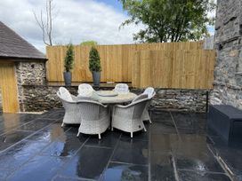 An outdoor seating area with a table and chairs at Fell View Cottage Lambrigg near Kendal
