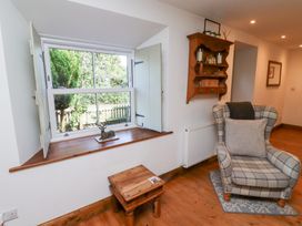 A living room with a window and a chair at Bruno's Bothy Middleton near Belford