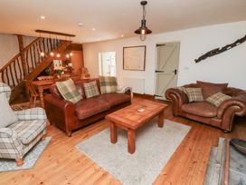A living room with a sofa and table at Bruno's Bothy Middleton near Belford