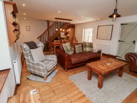 A living room with a sofa and coffee table at Bruno's Bothy Middleton near Belford