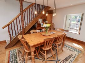 A dining room with a wooden table and chairs at Bruno's Bothy Middleton near Belford