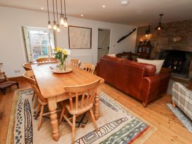 A dining room with wooden table and chairs at Bruno's Bothy Middleton near Belford