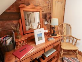 A dressing area with a mirror and lamp at Bruno's Bothy Middleton near Belford