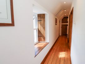 A hallway with a window and wooden door at Bruno's Bothy Middleton near Belford