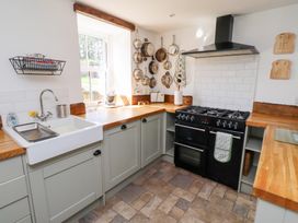 A kitchen with a sink and oven at Bruno's Bothy Middleton near Belford
