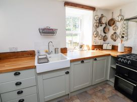 A kitchen with a sink and stove at Bruno's Bothy Middleton near Belford