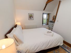 A bedroom with a bed and dresser at Bruno's Bothy Middleton near Belford