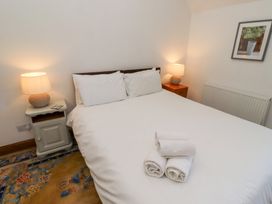 A bedroom with a bed and towels on top at Bruno's Bothy Middleton near Belford