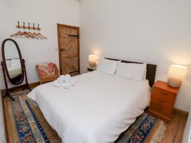 A bedroom with a bed and nightstand at Bruno's Bothy Middleton near Belford