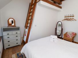 A bedroom with a bed and dresser at Bruno's Bothy Middleton near Belford