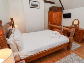 A bedroom with a bed and dresser at Bruno's Bothy Middleton near Belford