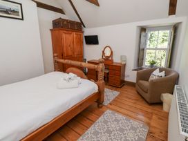 A bedroom with a bed and dresser at Bruno's Bothy Middleton near Belford