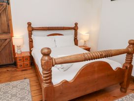 A bedroom with a bed and nightstand at Bruno's Bothy Middleton near Belford