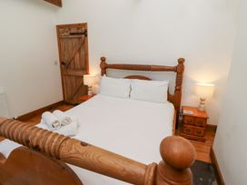 A bedroom with a bed and a nightstand at Bruno's Bothy Middleton near Belford