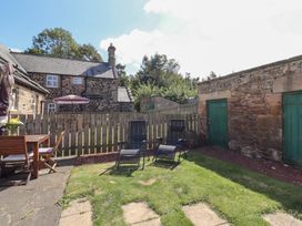 A garden with chairs and a table at Bruno's Bothy Middleton near Belford