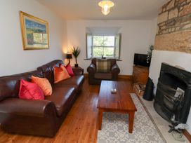 A living room with a sofa and a coffee table at Kits Cottage in Middleton near Belford