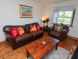 A living room with sofa and armchair at Kits Cottage Middleton near Belford