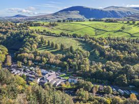 An aerial view of fields and buildings at Apartment 2 in Keswick