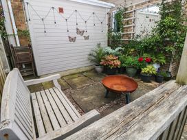 A garden with a bench and a fire pit surrounded by potted plants at Garden View in Pembroke