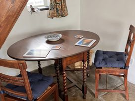 A dining room with a table and chairs at Lythe Cottage in Lythe