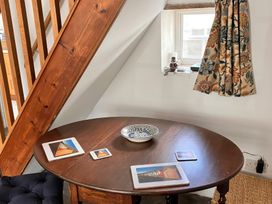 A dining area with a table and iPads at Lythe Cottage in Lythe