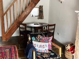 A dining room with a table and chairs at Lythe Cottage in Lythe
